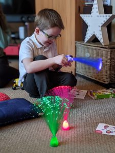 A boy playing with Caudwell Children Get Sensory Packs Fibre Optic Lamps